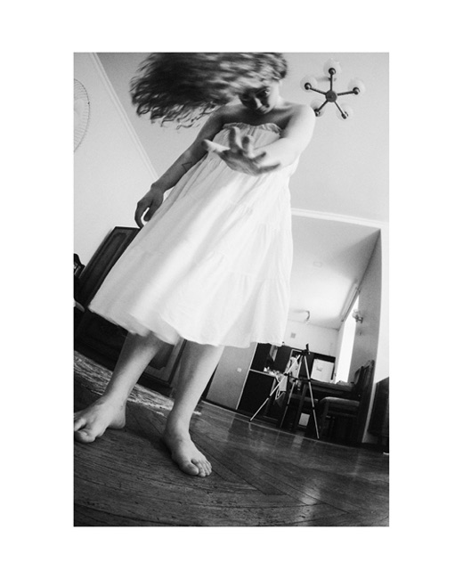 Aksana, photographed by Lilit L Hovhanni — a woman at home, seen through the rooms around her.