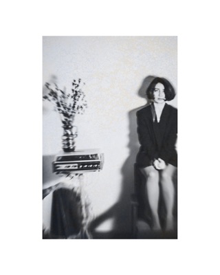 Lusine Baghdasaryan, photographed by Lilit L Hovhanni — seated at a tiled sink, in black and white.